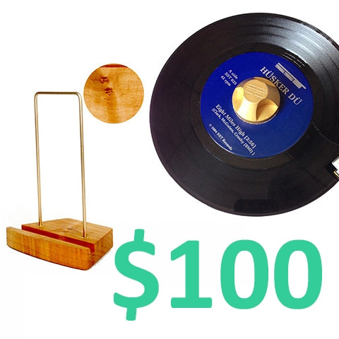 Seven inch vinyl record with brass and wood display stand