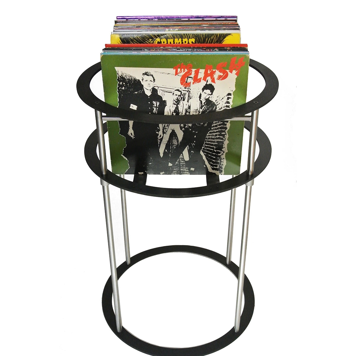 Green red yellow album covers on a black and silver metal pedestal