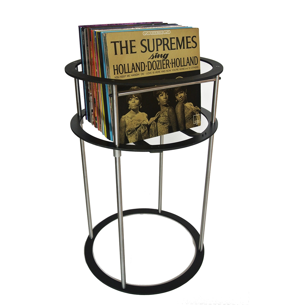 Black and gold album cover on a black metal pedestal