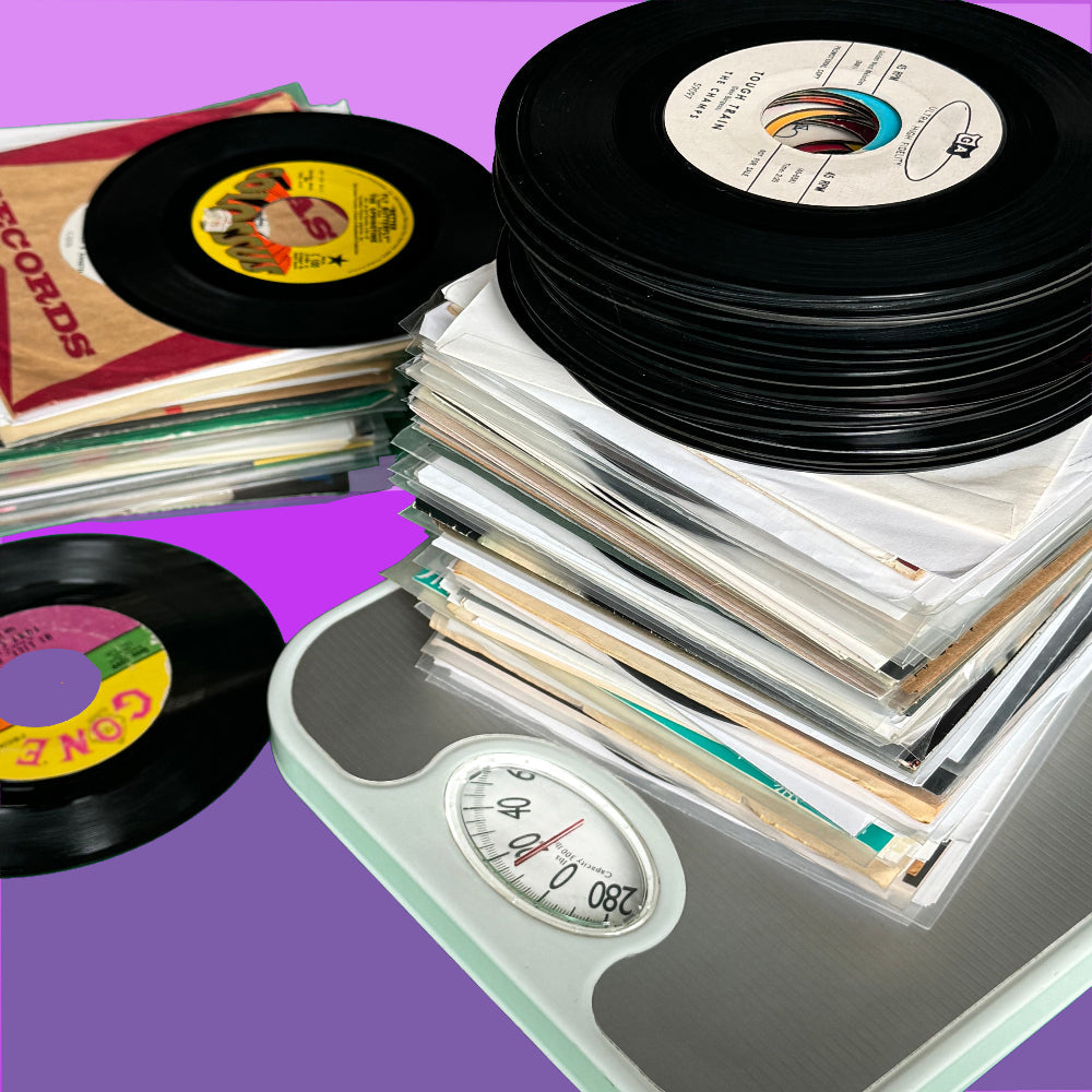 Ten inch tall stack of seven inch vinyl records placed on a scale showing the records weighs 10 lbs.