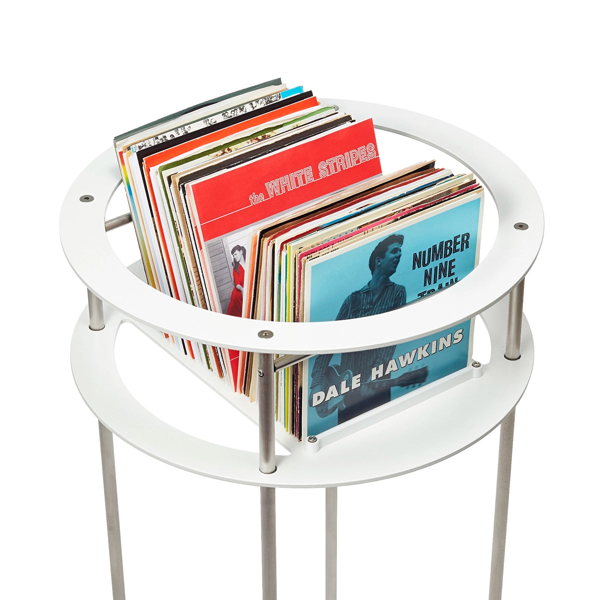 Red and blue cover art in a stack of seven inch records on a white circular pedestal