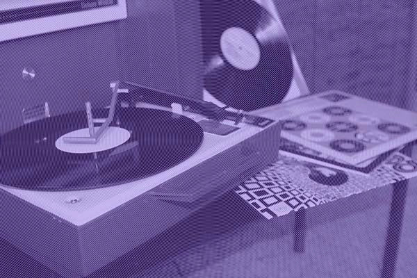 Vintage record player with vinyl records on a small table